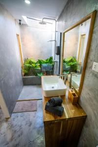 a bathroom with a sink and a mirror at Palayan Villa - Villa with views, garden and jacuzzi in El Nido