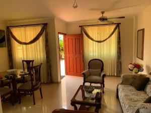 a living room with a couch and a table and chairs at Stone Creek Barranquilla in Barranquilla