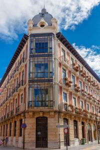 a large building on a street with a blue sky at Purple Dog Suites in León