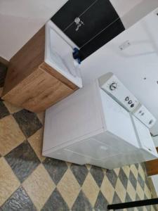 two white boxes sitting on a checkered floor at PRIMAVERA LIVING in Medellín