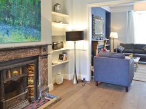 a living room with a fireplace and a couch at Burford in Penzance