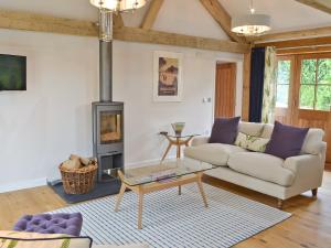 a living room with a couch and a fireplace at The Wagon House in Luxulyan