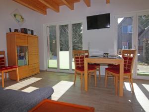 a living room with a dining room table and chairs at Doppelhaushälfte Lee in Zingst in Zingst