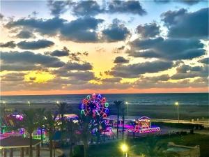 a roller coaster at the beach at sunset at مصيف بلطيم 