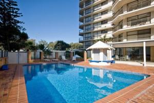 a swimming pool in front of a building at Surfers Paradise Apartment With Amazing Views in Gold Coast