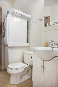 a white bathroom with a toilet and a sink at The Park Lodge in Washington