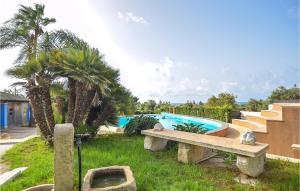 a swimming pool with a bench and palm trees at Beautiful Home In Pozzallo Rg in Pozzallo +19 photos