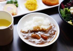 a bowl of food with rice and a cup of tea at APA Hotel TKP Keikyu Kawasaki Ekimae in Kawasaki