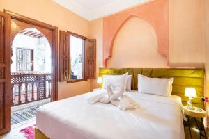 a bedroom with a bed with a towel on it at Central Entire and exclusive house ,Ryad no shared in Marrakesh