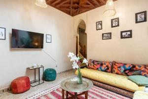 a living room with a couch and a table at Central Entire and exclusive house ,Ryad no shared in Marrakesh