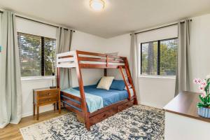 a bedroom with a bunk bed and two windows at Woodsy Retreat, steps to Bay - Hot tub! in Gulf Breeze