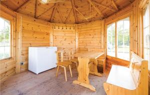 Cette cabane en bois dispose d'une table et d'un réfrigérateur. dans l'établissement Ferienhaus 5 Altefhr, à Altefähr