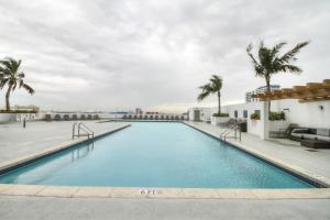 a swimming pool on the roof of a building with palm trees at ICONIC LUXURIOUS 2 br SUITE POOLVIEW & BAY VIEW DOWNTOWN MIAMI in Miami