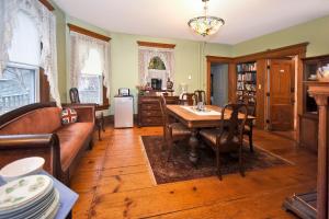 a living room with a table and a couch at Blooming Inn Shelburne Falls in Shelburne Falls