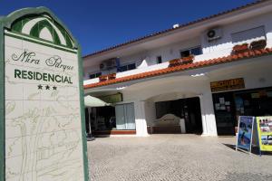 a sign in front of a building at Mira Parque in Albufeira