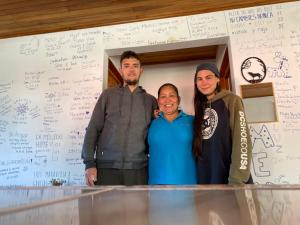 a group of three people standing in front of a table at Twin Palms Lodge in Monteverde Costa Rica