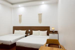 Giường trong phòng chung tại Sky Hotel - Dalat Vania