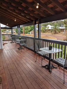 a patio with chairs and a table on a deck at Toodyay Manor in Toodyay