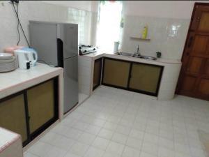 a kitchen with a refrigerator and a sink at Raja Homestay Kluang in Kluang