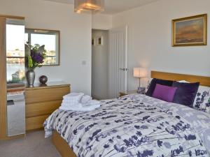 a bedroom with a bed with a black and white comforter at The Barnacle in Oulton