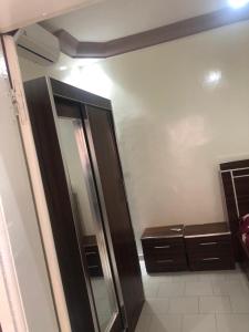 a bathroom with a shower and a glass refrigerator at Villa Al amine in Dakar