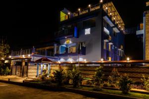 a hotel at night with lights in front of it at Panism Lifestyle in Auroville