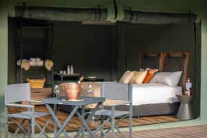 a bedroom with a bed and a table and chairs at Mt Mulligan Lodge in Mount Mulligan