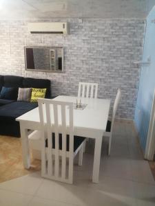 a white dining table and chairs in a living room at Salama House in Lusaka