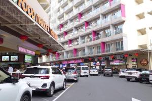a bunch of cars parked in front of a building at Tower A, 9th Floor, No 11 in Lubuk Baja Favehotel, Apartment in Nagoya Thamrin City in Nagoya