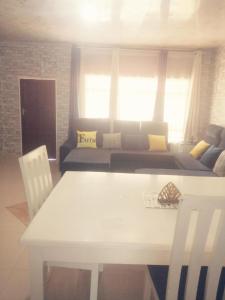 a living room with a white table and a couch at Salama House in Lusaka