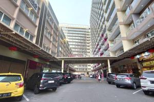 a parking lot with cars parked in a building at Tower A, 9th Floor, No 12 in Lubuk Baja Favehotel, Apartment in Nagoya Thamrin City in Nagoya