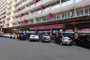 a parking lot with cars parked in front of a building at Tower A, 9th Floor, No 12 in Lubuk Baja Favehotel, Apartment in Nagoya Thamrin City in Nagoya