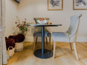 a table with two chairs and a bowl on top of it at Rum Studio - Ukc6564 in Mallaig