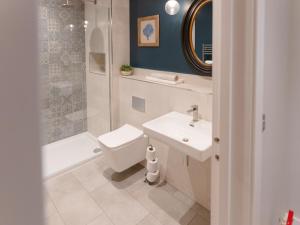 a bathroom with a sink and a toilet and a shower at Rum Studio - Ukc6564 in Mallaig
