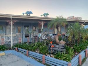 a house with palm trees and plants in front of it at Michaels Siesta Studios in Redington Shores