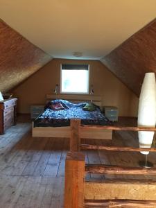 a bedroom with a bed in a attic at Liten stuga mitt i naturen på Kinnekulle in Hällekis