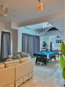 a living room with a ping pong table in it at Shah Alam Setia Alam SCCC 3 Storey Semi D 13 Pax in Shah Alam