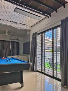 a living room with a pool table and a sliding glass door at Shah Alam Setia Alam SCCC 3 Storey Semi D 13 Pax in Shah Alam