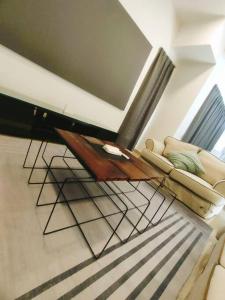 a living room with a couch and a coffee table at Shah Alam Setia Alam SCCC 3 Storey Semi D 13 Pax in Shah Alam