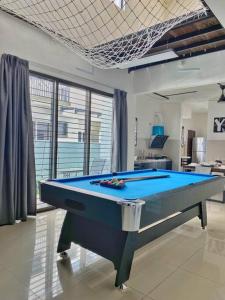 a pool table sitting in a living room with at Shah Alam Setia Alam SCCC 3 Storey Semi D 13 Pax in Shah Alam