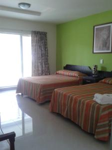 Postel nebo postele na pokoji v ubytování Hotel Playa Azul
