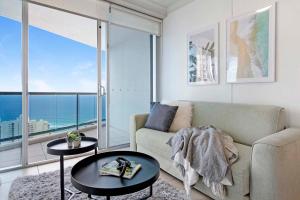 a living room with a couch and a view of the ocean at Chevron Renaissance - Self Contained Apartments - Wow Stay in Gold Coast
