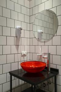 a bathroom with a red sink and a mirror at Velasco House in Buenos Aires