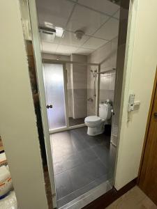 a bathroom with a toilet and a shower in it at 觀心農舍 民宿 Ageless Farmhouse in Sanyi