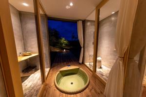 高松市にあるオリーブの宿 澳邸のバスルーム(緑のトイレ付)が備わります。