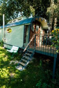 un wagon avec un escalier menant à une maison dans l'établissement historischer Zirkuswagen inmitten der Natur, à Fischach