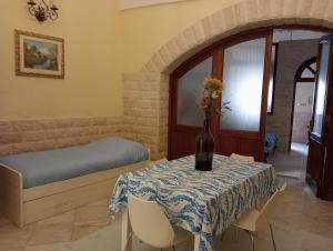 a room with a table with a vase of flowers on it at Appartamento Centrale in Molfetta