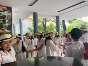 Un groupe de personnes en uniforme et chapeau blancs dans l'établissement Heritage By Night, à Lang Va