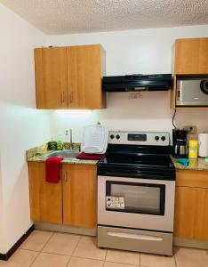 a kitchen with a stove and a sink at Beautiful Apartment w/ Balcony Family Friendly in San Rafael