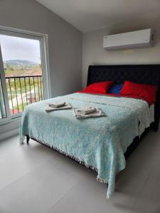 a bedroom with a bed and a window with a view at White coral house in Dalaman